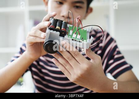 Student learning STEM education robotics for creating project studying for innovation robot models. New study generation for DIY electronic kits in ma Stock Photo