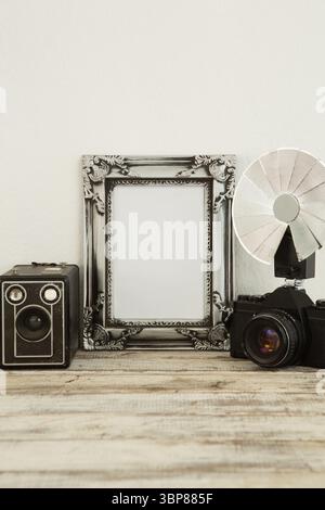 Photo frame, speaker and camera on table Stock Photo