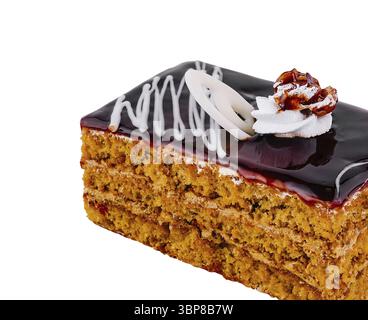 Food, Slice of layered sponge cake with chocolate topping is decorated with white chocolate curls, whipped cream and walnut Stock Photo