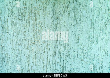 Vintage light green, pastel background of plastered wall. Textured teal wall with vertical relief patterns from stucco application. Concept of Stock Photo