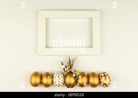 Easter festive decoration. Top view of easter eggs colored with golden paint and empty mock-up photo frame. Various dotted designs. White background Stock Photo