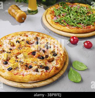 Food, Two different pizzas served on wooden boards with a glass of beer, perfect for sharing with friends at a restaurant or at home Stock Photo