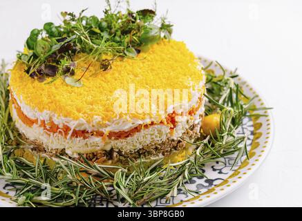 Food, Vibrant layered salad decorated with herbs and edible flowers, served on an ornate plate Stock Photo