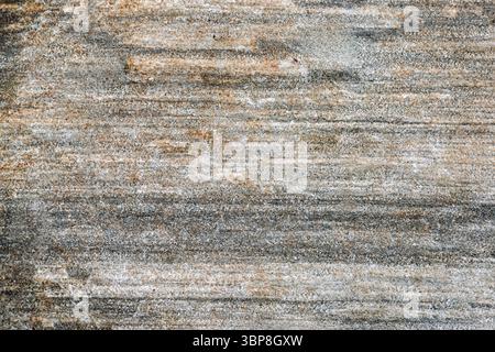 Natural stone surface displays a blend of earthy tones with textured patterns formed by time and elements, providing a rustic aesthetic. Stock Photo