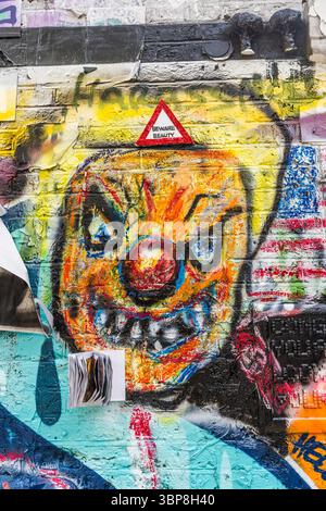 Colorful murals on a brick wall at the corner of Buxton Street and Brick Lane in the East End, a famous cultural landmark in London, United Kingdom Stock Photo