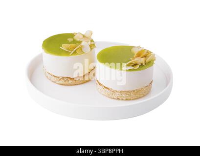 Food, Two individual lime cheesecakes with almond slices on a white plate, isolated on white background Stock Photo