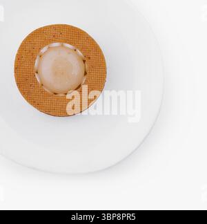 Food, Single orange sphere centered on a textured mat against a white background, portraying minimalism Stock Photo