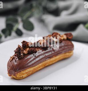 Food, Eclair with Chocolate Cream and Hazelnuts Stock Photo