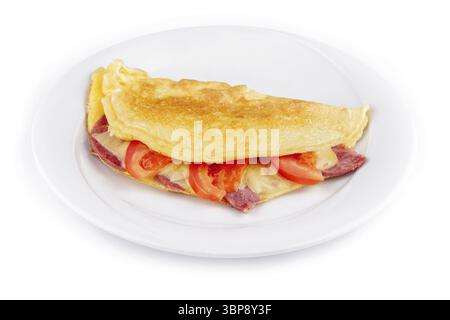 Food, Delicious folded omelette filled with cheese, ham and tomatoes, served on a white plate, isolated on a white background Stock Photo