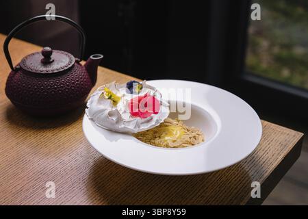 Food, Meringue on plate and almonds with vanilla custard Stock Photo