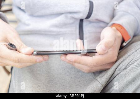 Close up of a man using modern black smart phone Stock Photo