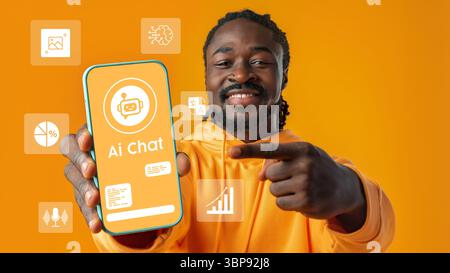 Smiling man showcasing an AI chat application on a smartphone against a vibrant orange background Stock Photo