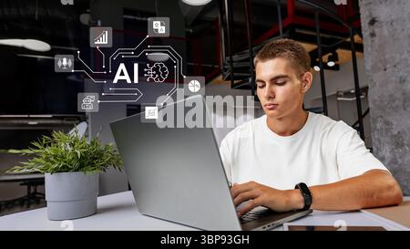 Young man engages in artificial intelligence project while working on a laptop in a modern office space during the day Stock Photo