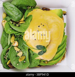 Food, Avocado sandwich and poached eggs on rye bread Stock Photo