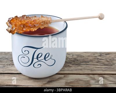 Black Tea and cup with rock sugar isolated on white background Stock Photo