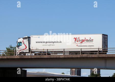 A white Virginia Logistics articulated lorry with a rigid trailer traveling logistics on the A5 bypass in Tamworth, UK. Stock Photo