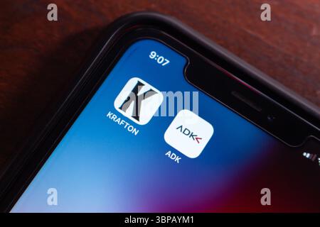 Mexico City, MEXICO - Jul 4 2025 : Zoomed-in smartphone screen showing KRAFTON and ADK app icons, representing gaming and digital media platforms. Stock Photo
