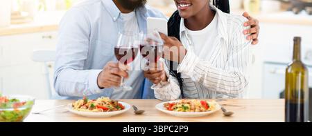 Young Black Lovers Taking Photos On Smartphone While Having Date At Home Stock Photo