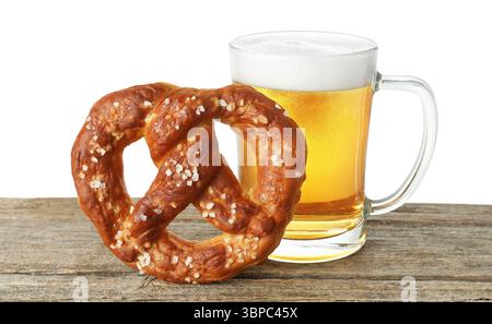 Tasty pretzel and glass of beer on wooden table against white background Stock Photo