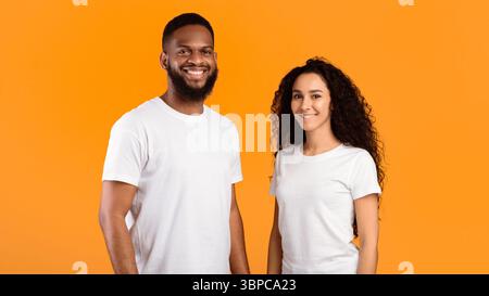 Multiethnic Couple Posing Standing Over Yellow Studio Background, Panorama Stock Photo