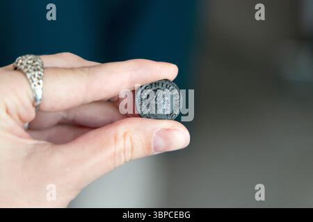 Roman coin minted in London (Londinium) found around the Thames, London, England Stock Photo