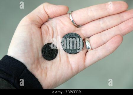 Roman coins minted in London (Londinium) found around the Thames, London, England Stock Photo