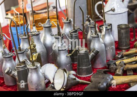 Used oil cans, oil spray cans for lubricating oil for vehicle maintenance. Vintage car trade fair Retro Classics in Stuttgart, Baden-Wuerttemberg, Ger Stock Photo