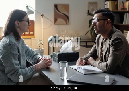 Woman Talking with Man during Therapy Stock Photo