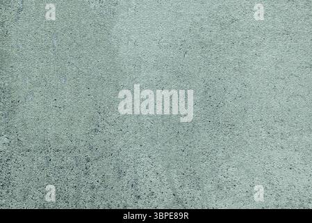 Close-up view of a green concrete wall featuring a textured surface, suitable for grunge backgrounds Stock Photo