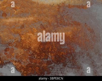 Orange and grey watercolor painting creating a textured, abstract background with a moody, ethereal atmosphere Stock Photo