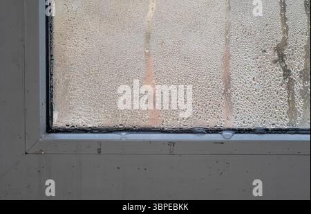 humidity and dampness on the window. The paint is coming off on the windowsill Stock Photo