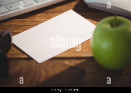 Keyboard and mouse by apple on table Stock Photo