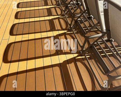 Shadows of sun loungers on the deck of a cruise ship Stock Photo