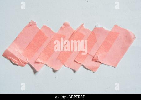 A group of torn pink masking tapes on white paper with clipping path Stock Photo