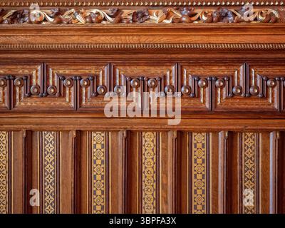 Detail of the intricate and beautifully carved wooden wall panelling inside the opulent Palau Güell, a mansion by Antoni Gaudí in Barcelona, Spain. Stock Photo