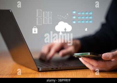 Business man work with laptop seek data input and output from data icon floating on screen Stock Photo