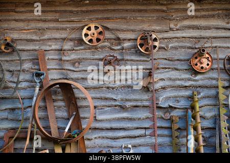 Close up of oall farm tools hanging on an exterior wooden building in rural Tennessee. Stock Photo