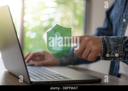Business man work with laptop touch lock icon floating on screen Stock Photo