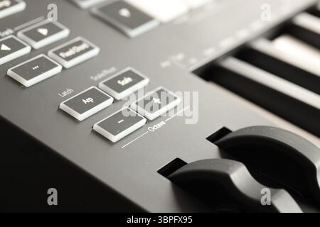 MIDI keyboard with buttons and faders, closeup Stock Photo