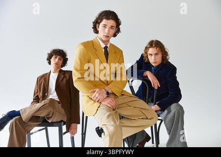 Three young men display their unique style while posing creatively with confidence and flair Stock Photo