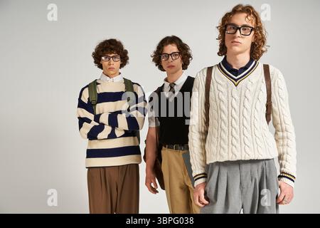 Three young men display their unique style with trendy outfits and fashionable accessories. Stock Photo