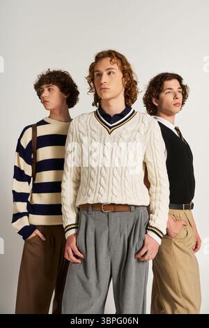 Three young men display their unique styles, blending trendy outfits with elegant flair. Stock Photo