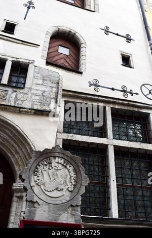 Ornate Stone Carving and Wrought Iron on Historic Tallinn Building Stock Photo
