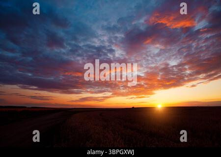 Perfect red clouds illuminated by the beams of the sun. Scenic image of textured sky. Photo of ecology concept. Breathtaking natural wallpaper backgro Stock Photo