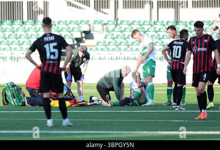 The New Saints' Leo Smith (centre) is stretched off the field following ...