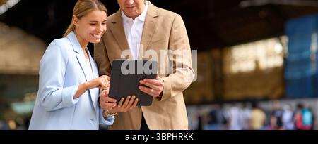 Business Professionals Engaging in Collaborative Discussions on a Digital Tablet Device Stock Photo