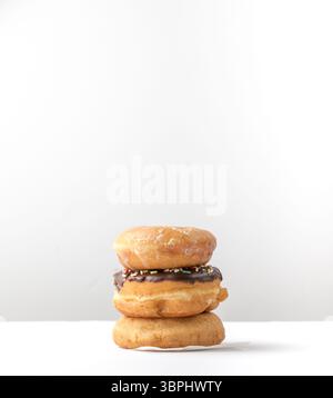 tower of assorted donuts isolated on white background Stock Photo