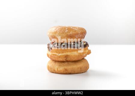 tower of assorted donuts isolated on white background Stock Photo