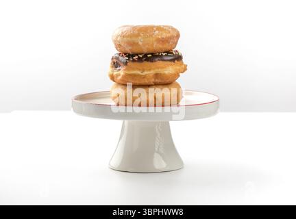 tower of assorted donuts isolated on white background Stock Photo