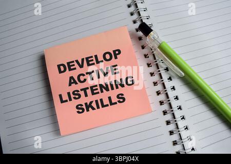 Develop active listening skills message written on ripped torn yellow ...